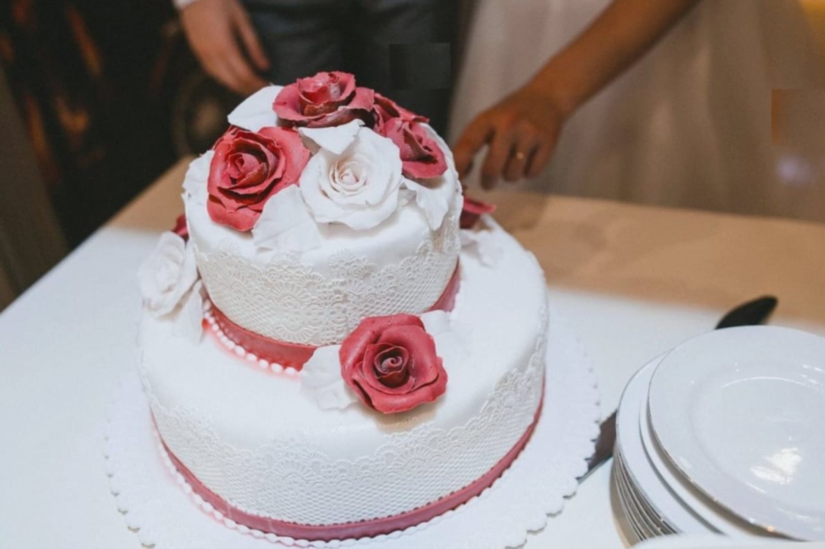 Tiered wedding cake topped with fresh flowers